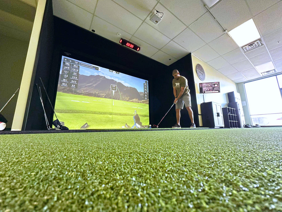 Man playing sim golf in a commercial facility.