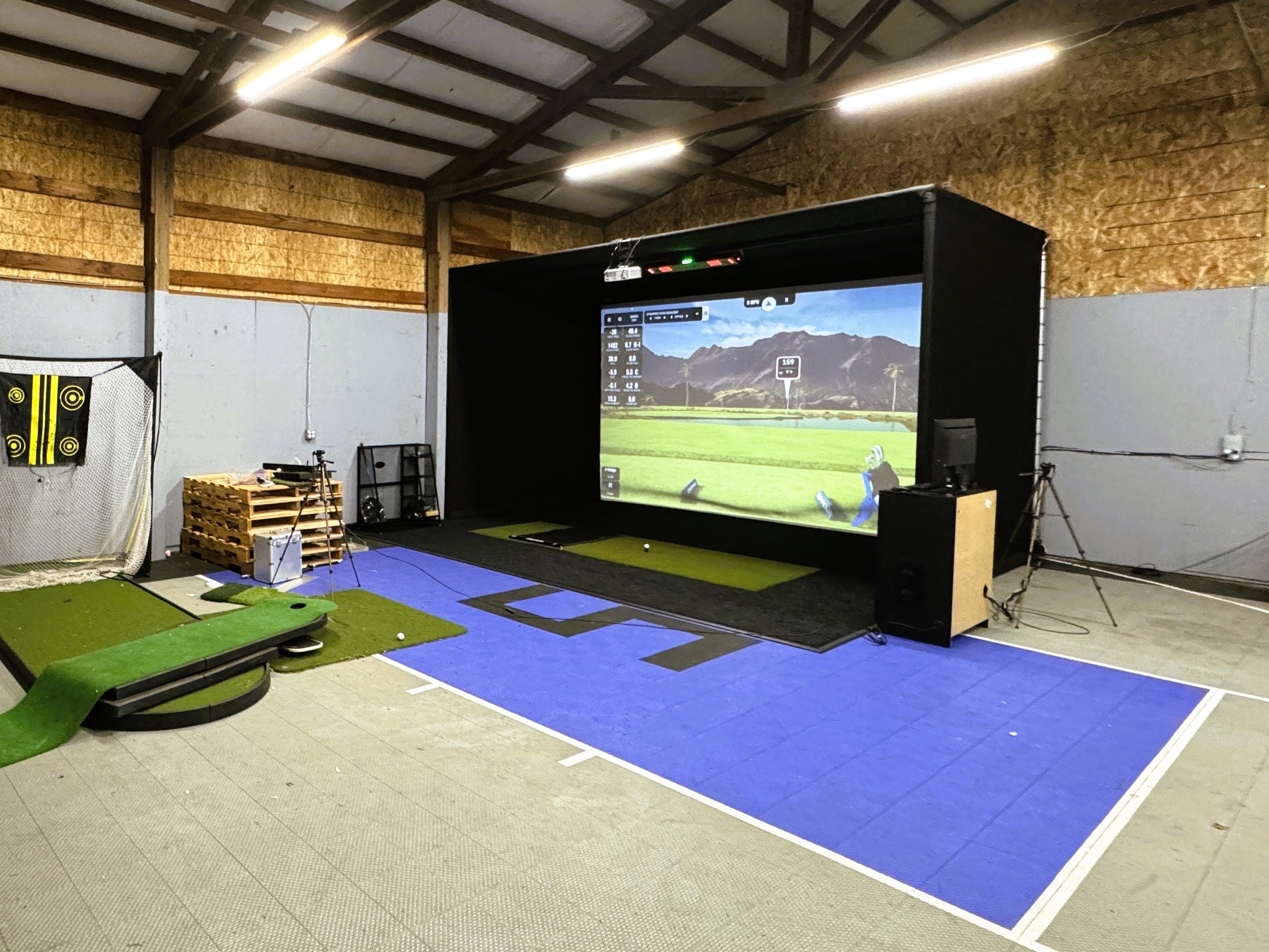 A large outbuilding with a golf simulator in Wilsonville, featuring the Uneekor EYE XO2 launch monitor.