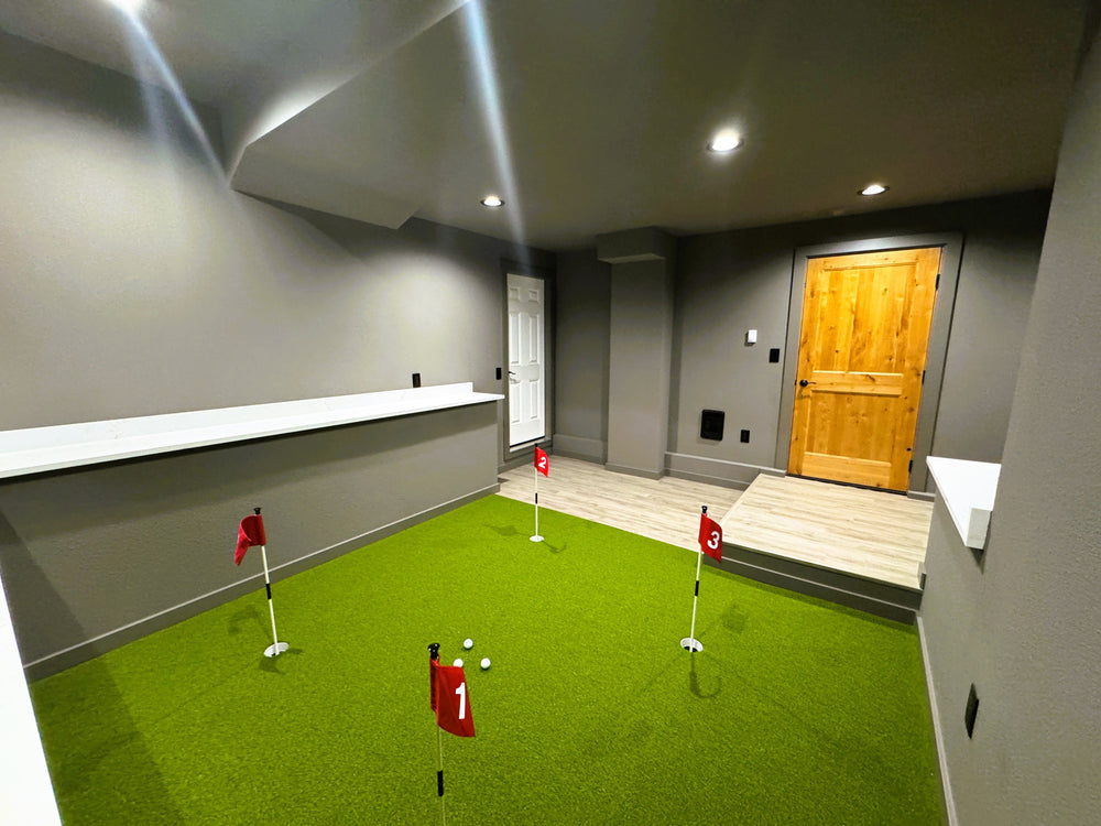 A putting green with four holes in a basement.