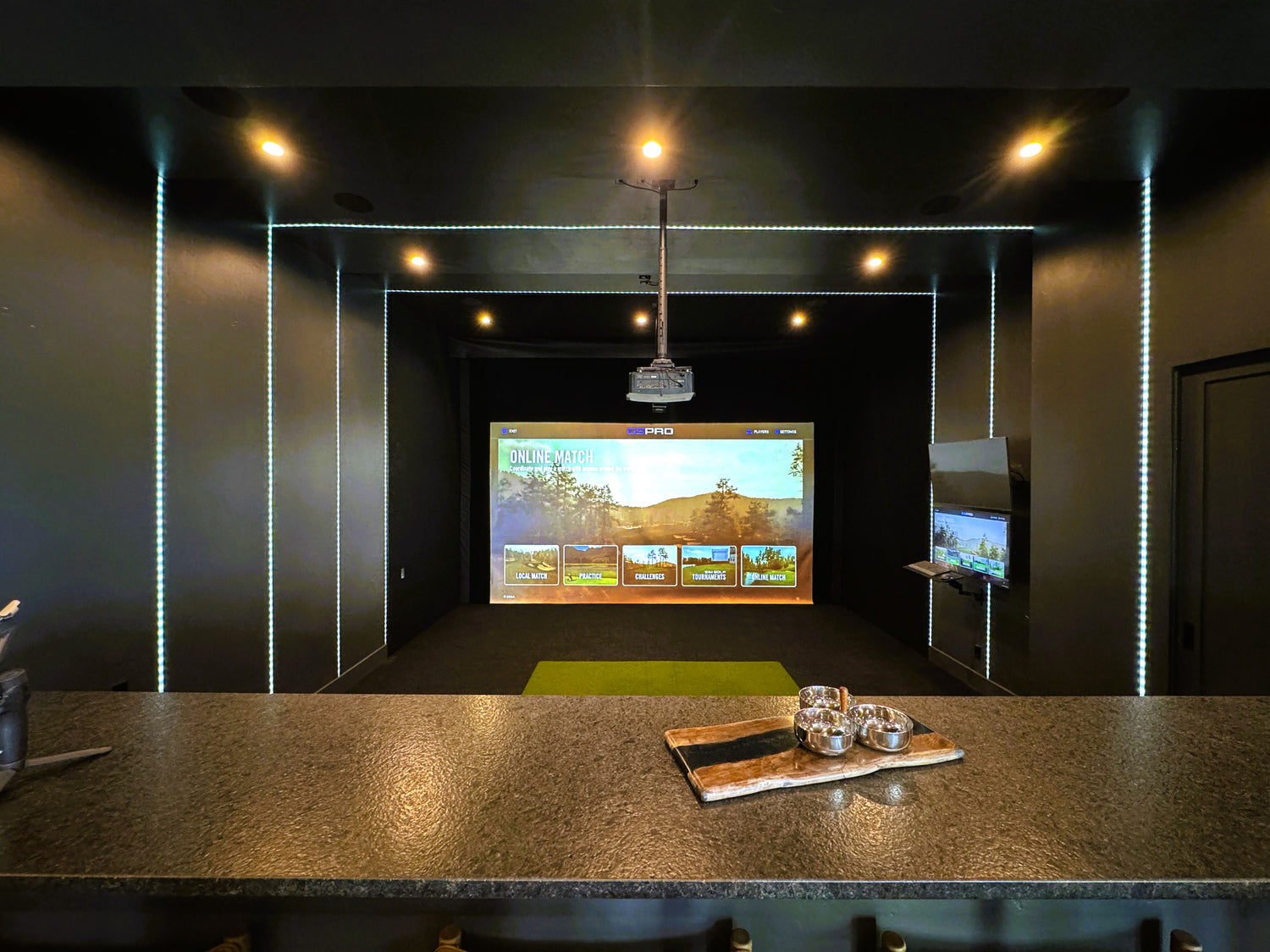 Uneekor EYE XO golf simulator in a basement