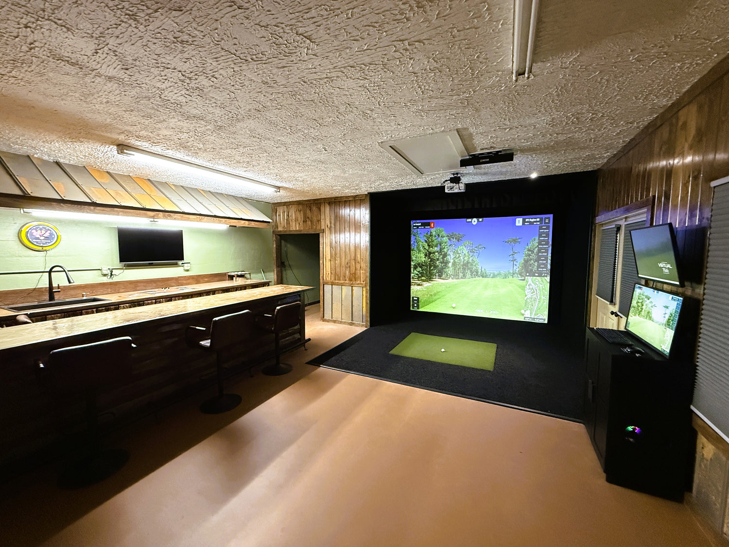 Custom golf simulator in a space with a bar top