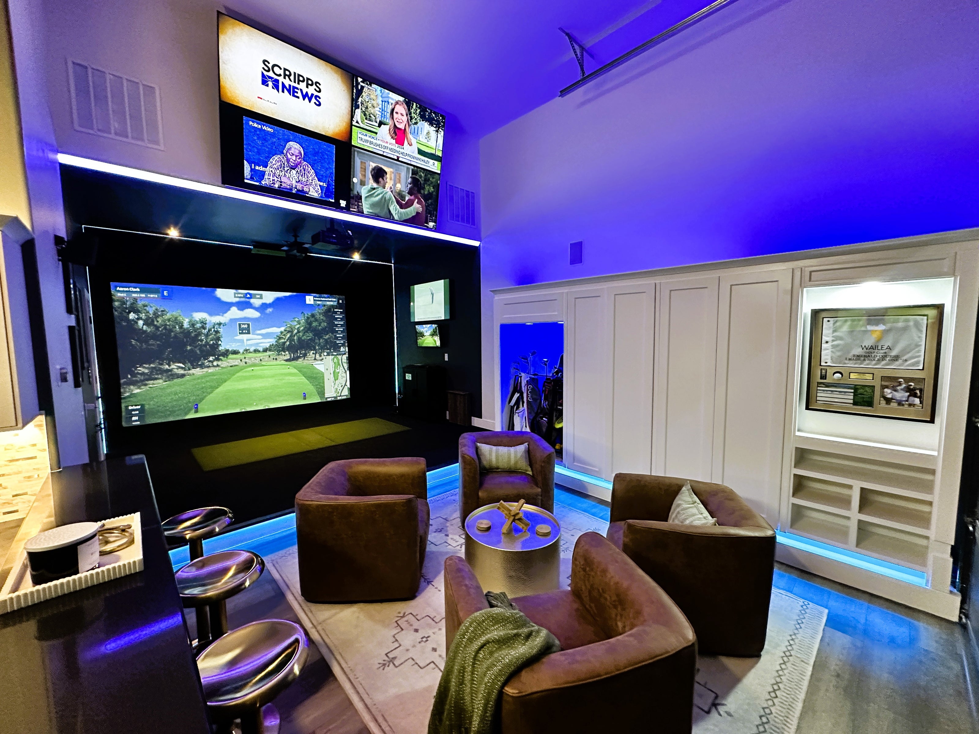 Custom golf simulator with LED lights and back seating.