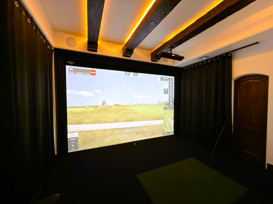 Golf simulator setup with a large screen displaying a virtual landscape.