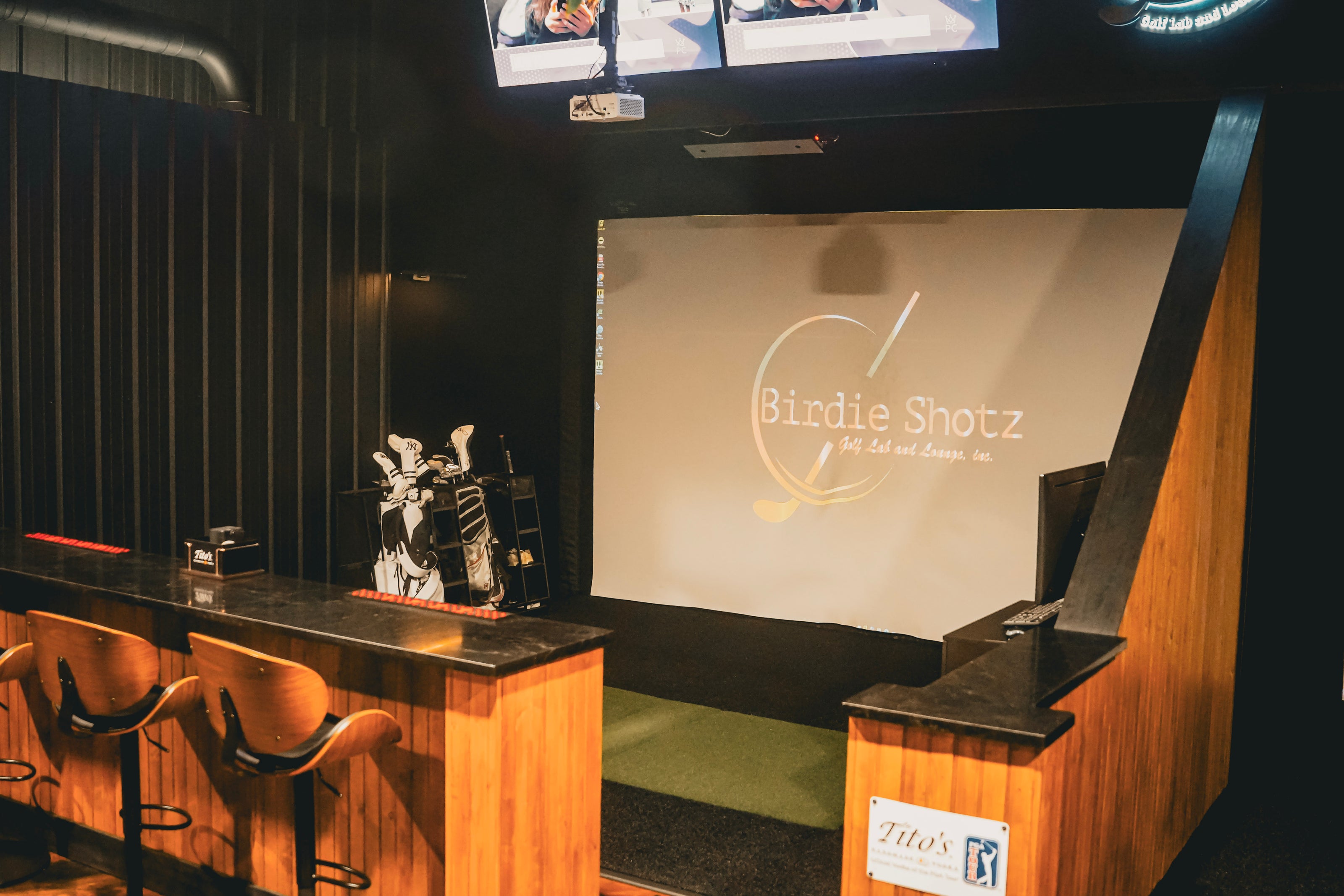 Golf Simulator with 'Birdie Shotz' branding in a bar setting