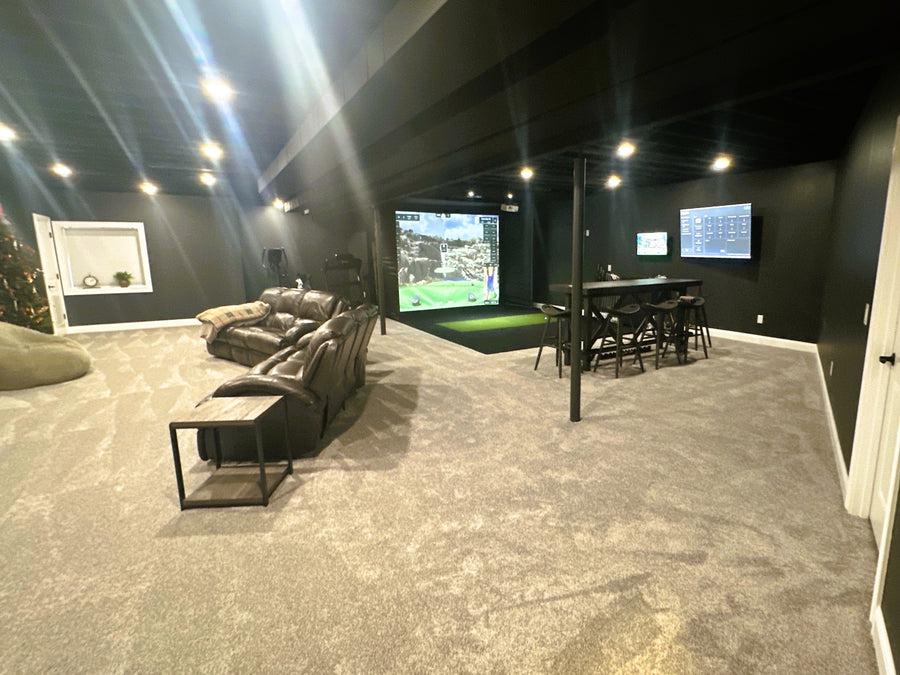 Golf simulator, large screen TV, and gaming setup.