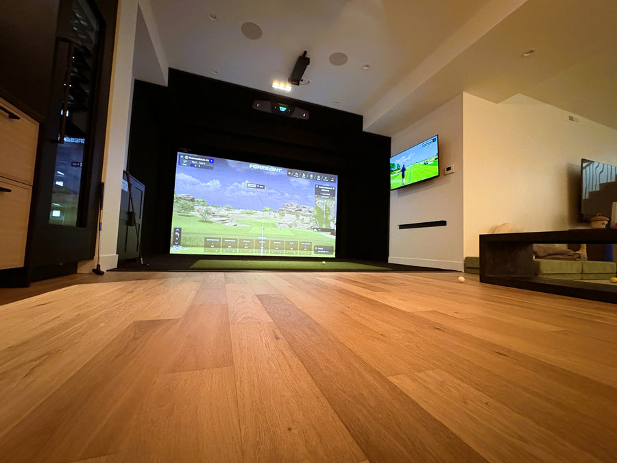 Golf simulator with large screen displaying a video game