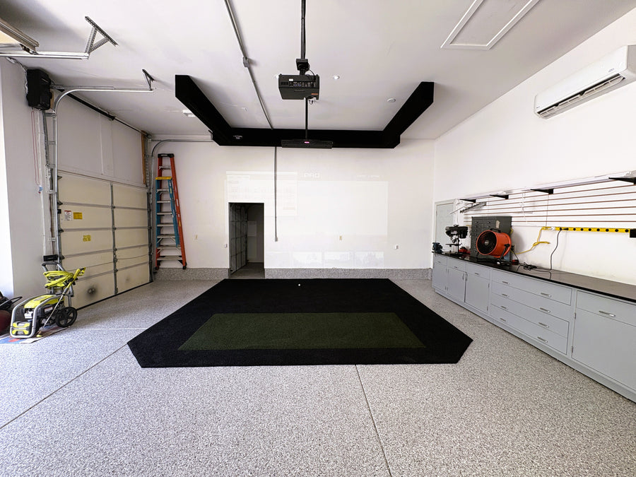 Modern garage with concrete floor, white walls, and various tools and equipment.