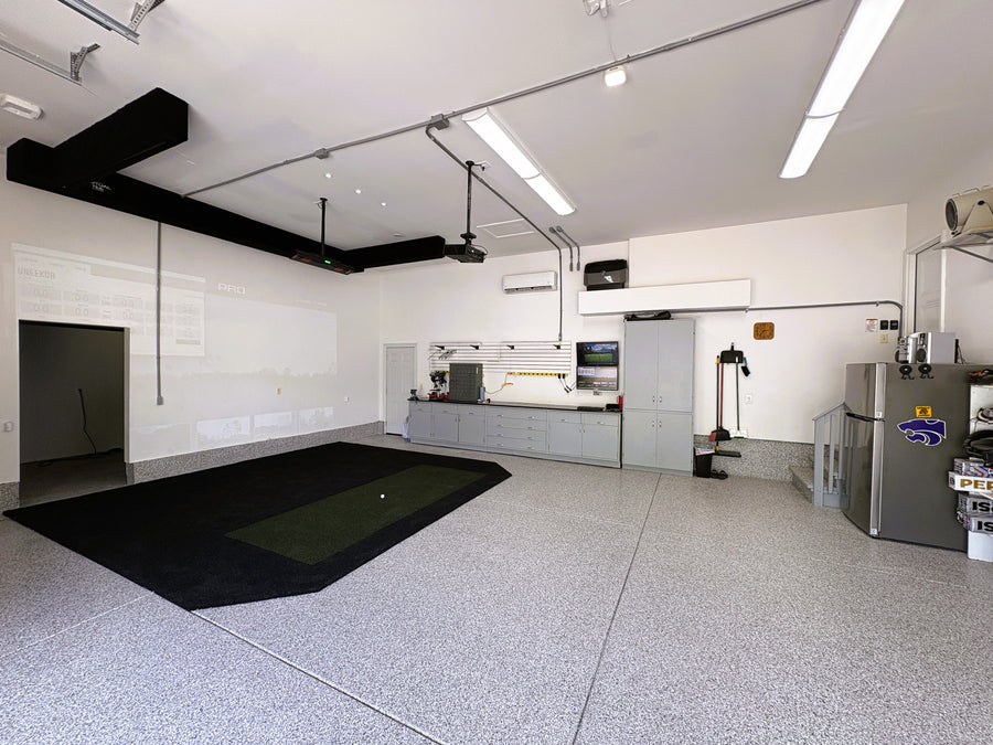 Modern garage with epoxy floor, tools, and equipment.