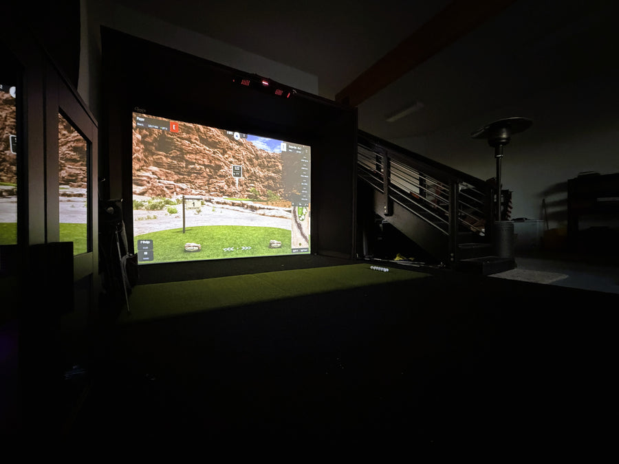 Garage golf simulator, with massive screen displaying golf round