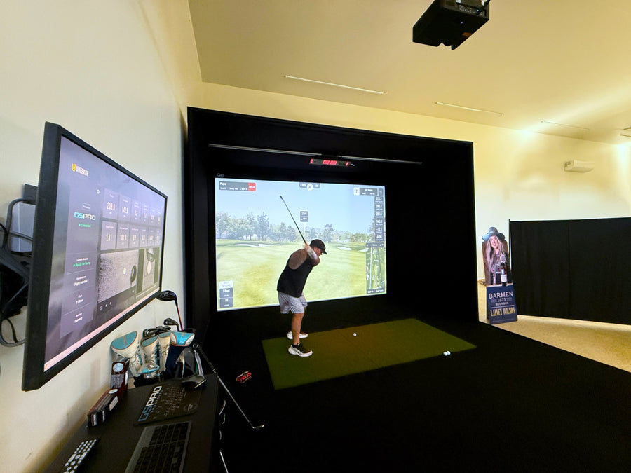 Golf simulator setup with two screens showing a golf game.