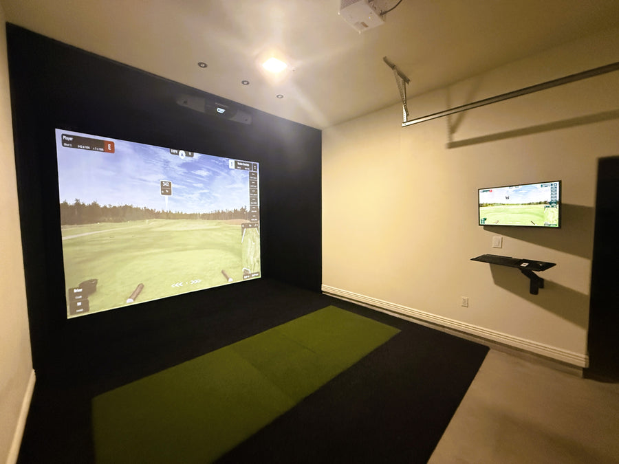 Golf simulator setup with two screens in a room.