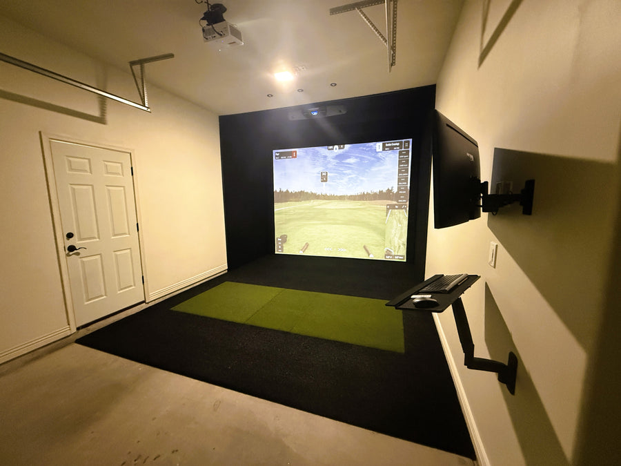 Golf simulator setup in a garage with a screen displaying a golf course.