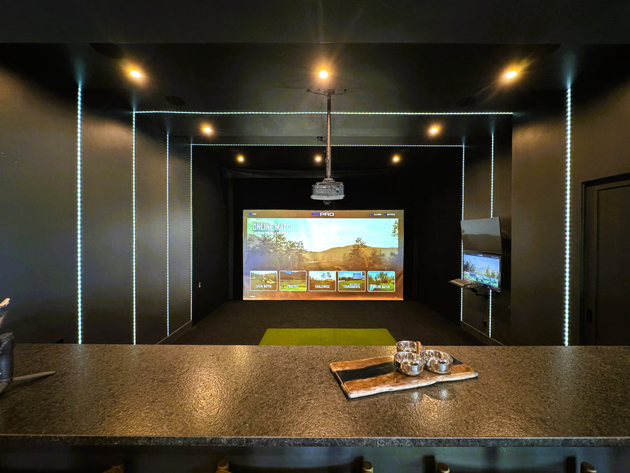 Uneekor EYE XO golf simulator in a basement