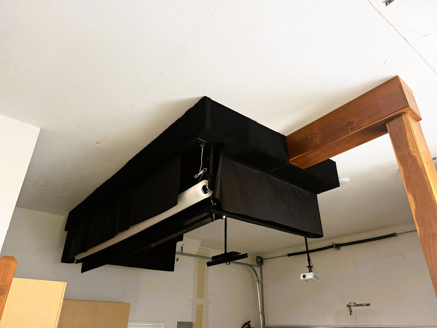 Retractable golf simulator setup in a garage with wooden beams.