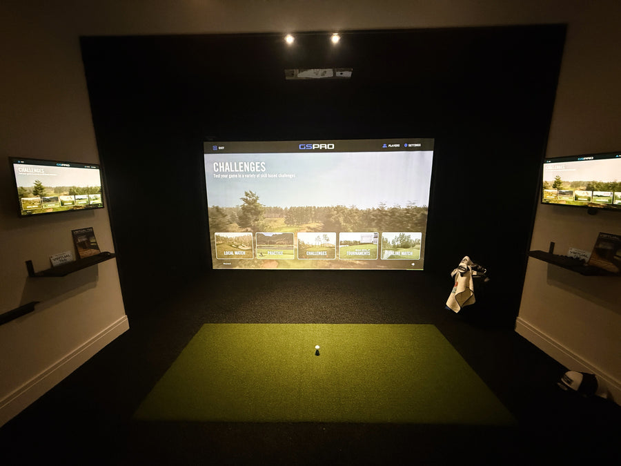 Golf simulator setup with a screen displaying a golf course and a person holding a golf club.