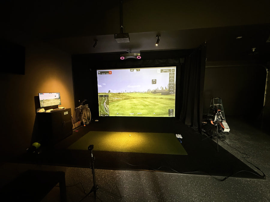 Garage golf simulator with lounge and watching area.