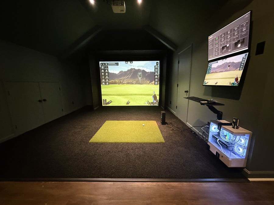 Indoor golf simulator setup with two screens displaying a golf course.