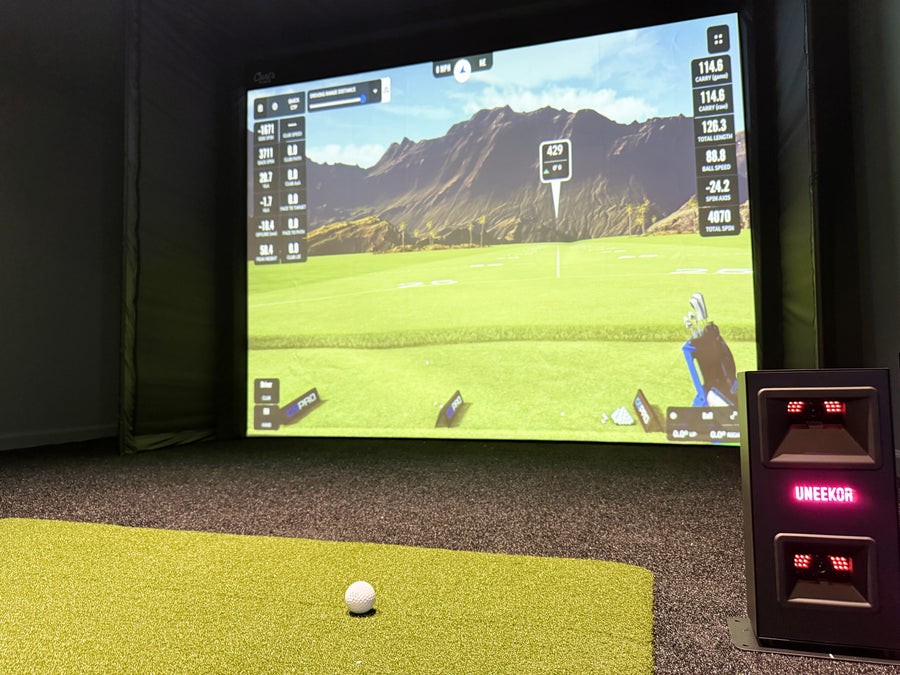 Indoor golf simulator with Uneekor launch monitor.