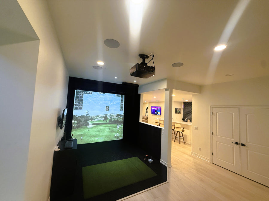 Indoor golf simulator setup in a home entertainment room.