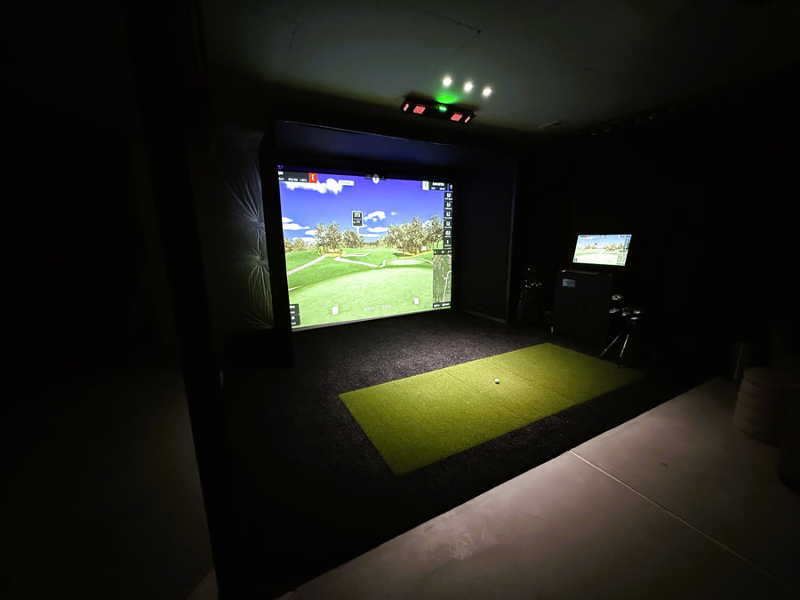 home golf simulator with black turf and custom hitting lights
