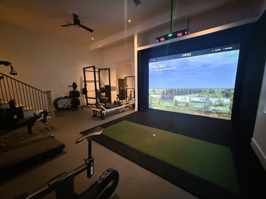 Gym with a golf simulator screen displaying a virtual golf course