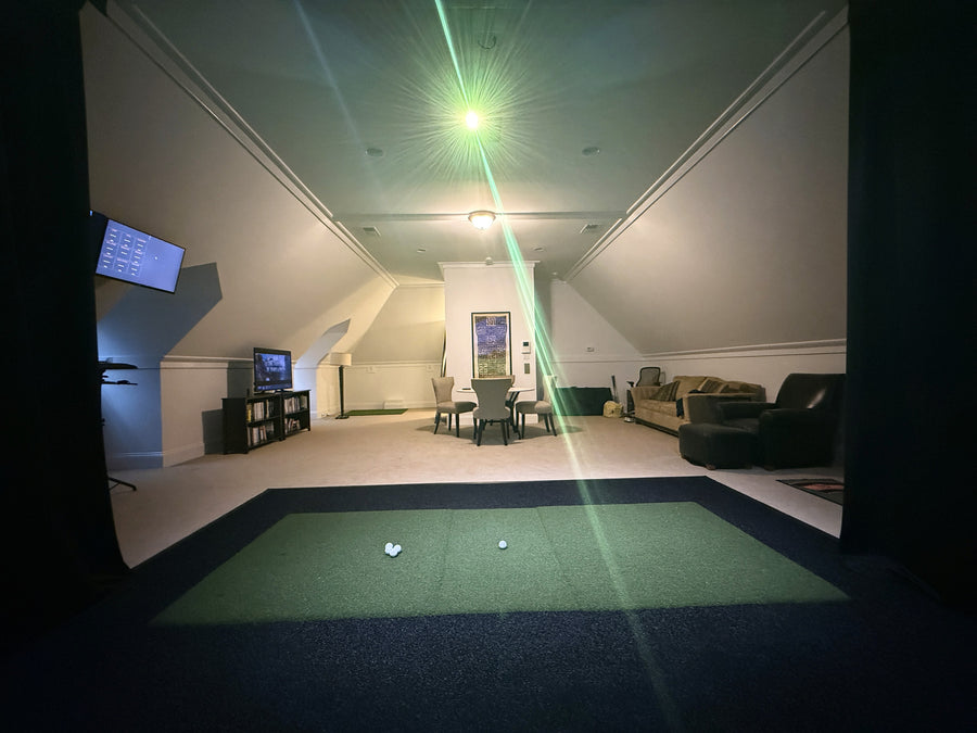 Indoor golf simulator in a living room setting.