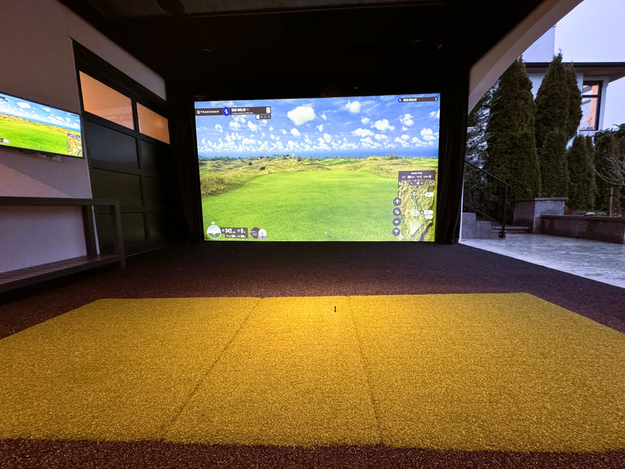 Outdoor golf simulator with a large screen displaying a golf course.
