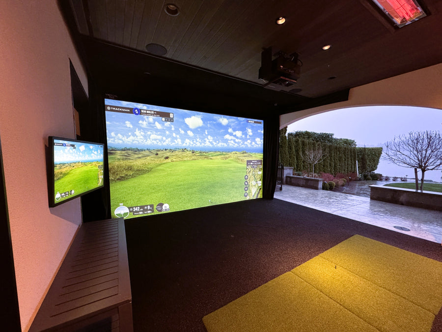 Outdoor golf simulator setup with two screens displaying a golf course.