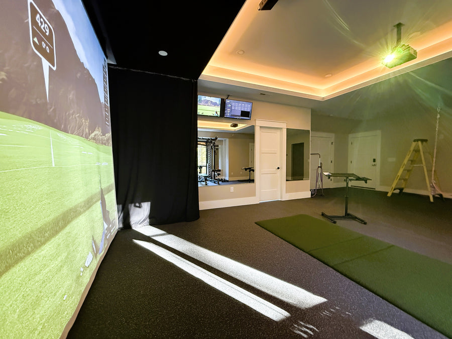 Retractable golf simulator with screen and equipment.