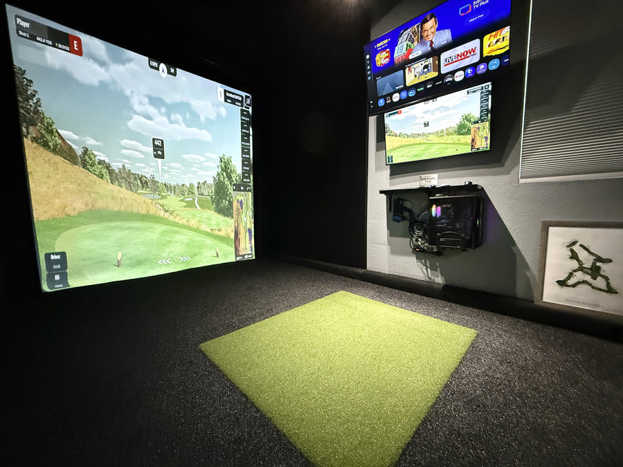 Golf simulator setup with two screens displaying a golf game and a TV with additional content.
