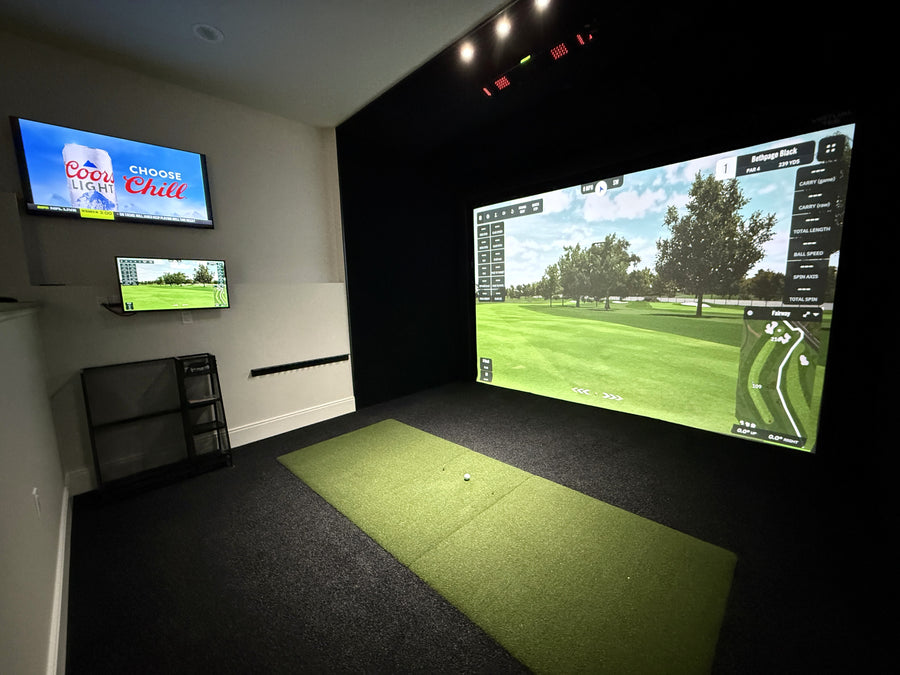 Home golf simulator setup with multiple screens displaying different content.