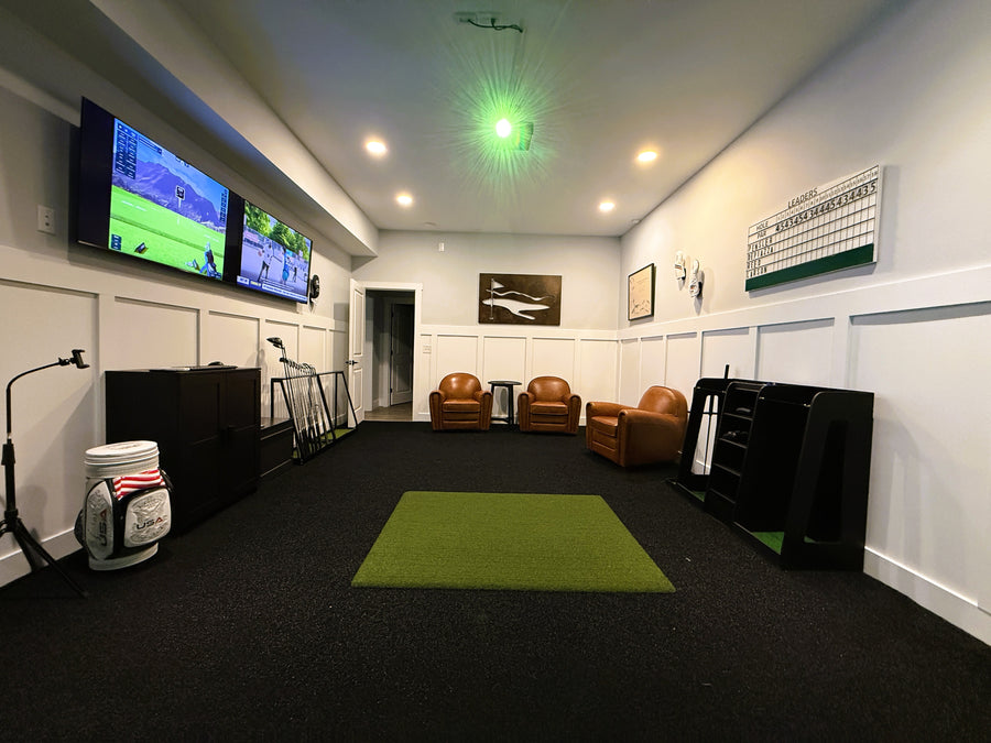 Golf simulator room with TV, chairs, and golf equipment.