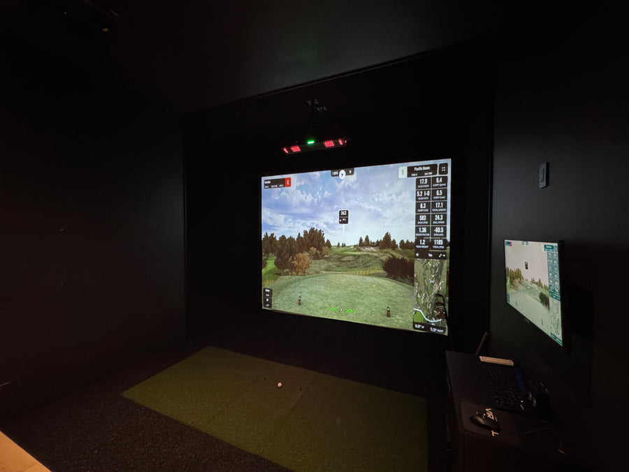 Video game screen in a dark room with a first-person shooter game displayed.