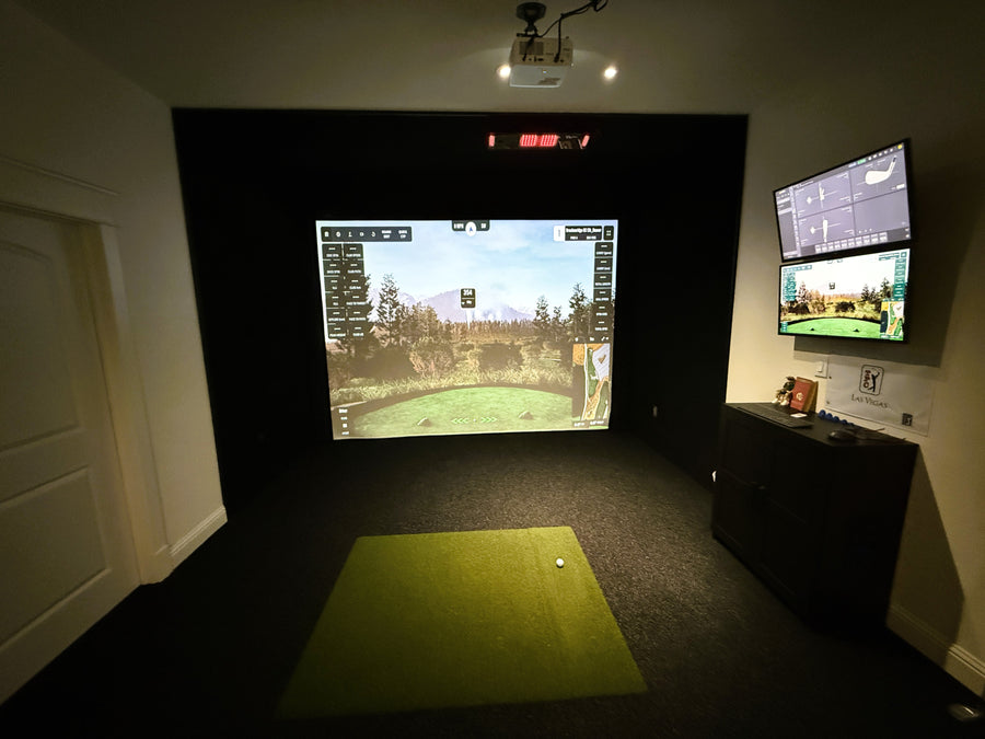 Indoor golf simulator setup with two screens displaying golf games.