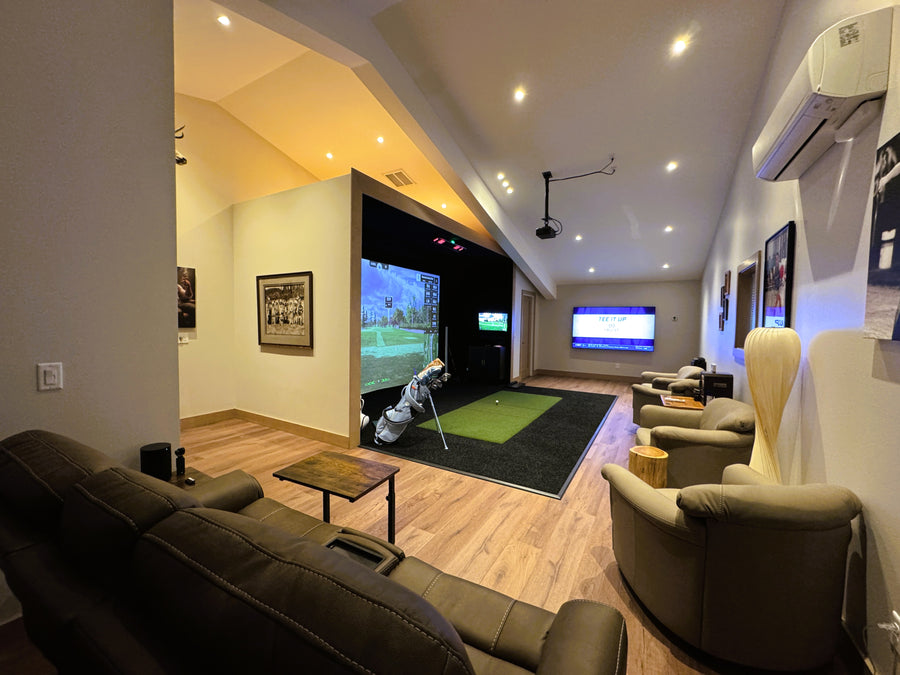 Modern living room with a golf simulator setup featuring a large screen displaying a golf simulation game.