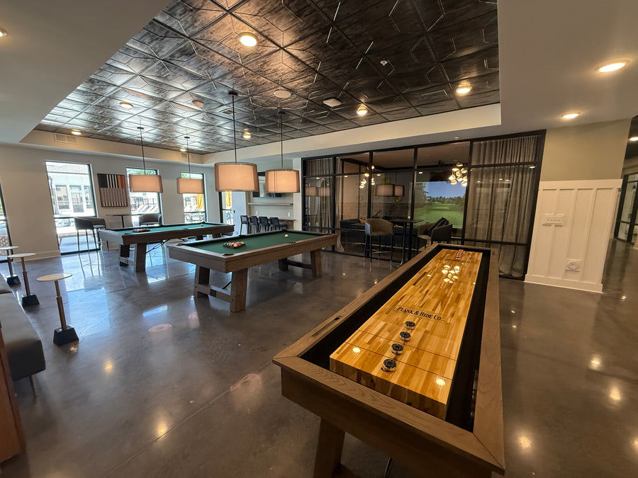 Game room with shuffle board table and pool tables