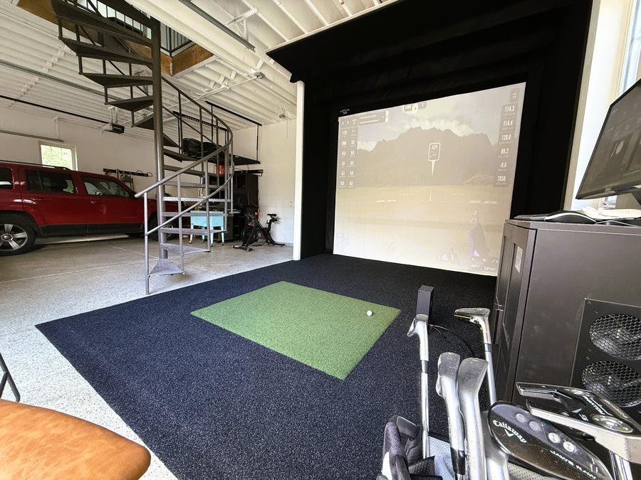 Garage golf simulator setup displaying a round of golf, with car in background.