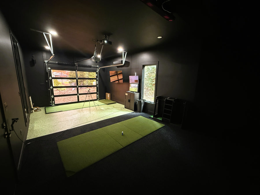 Indoor golf simulator, large windows, and a garage door.