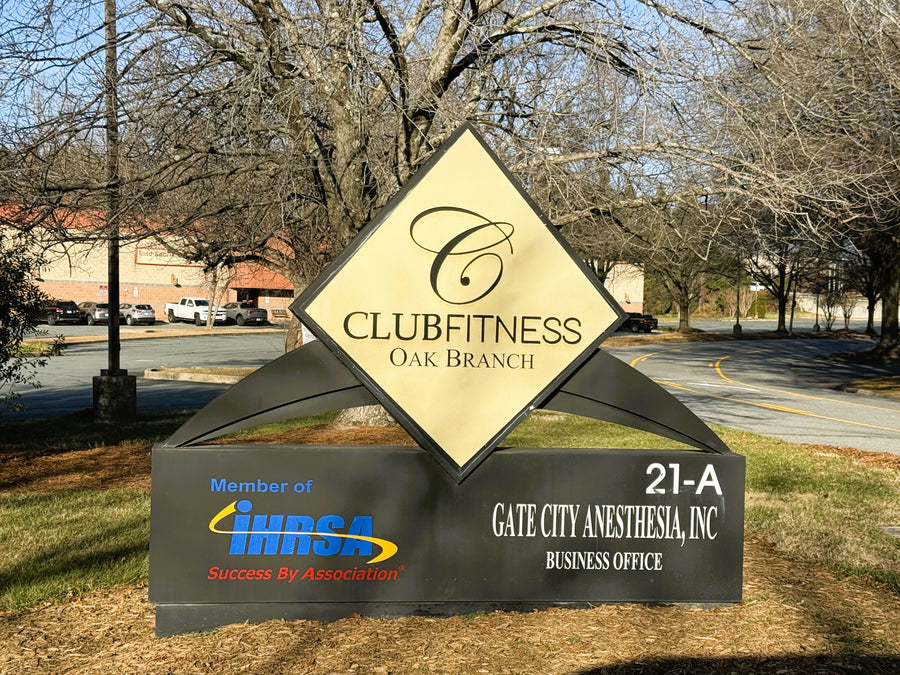Club Fitness Oak Branch sign with an golf simulator inside.