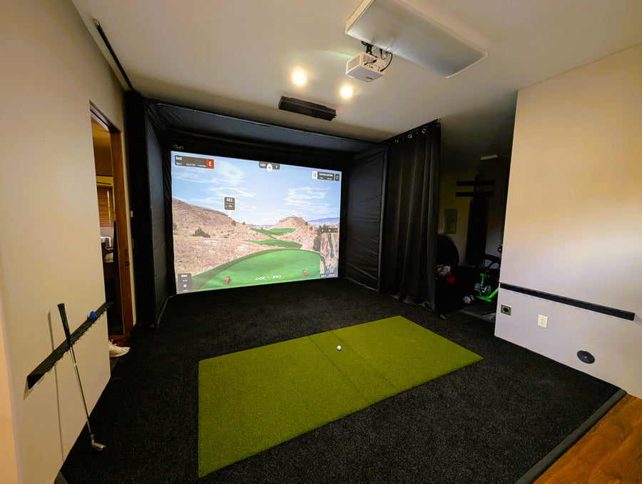 Golf simulator cage setup in a basement.