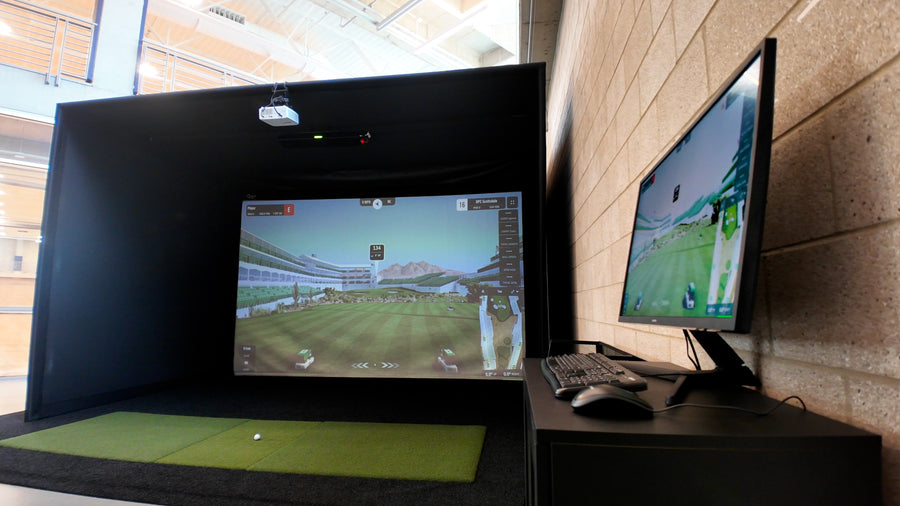Golf simulator displaying a golf simulation game.