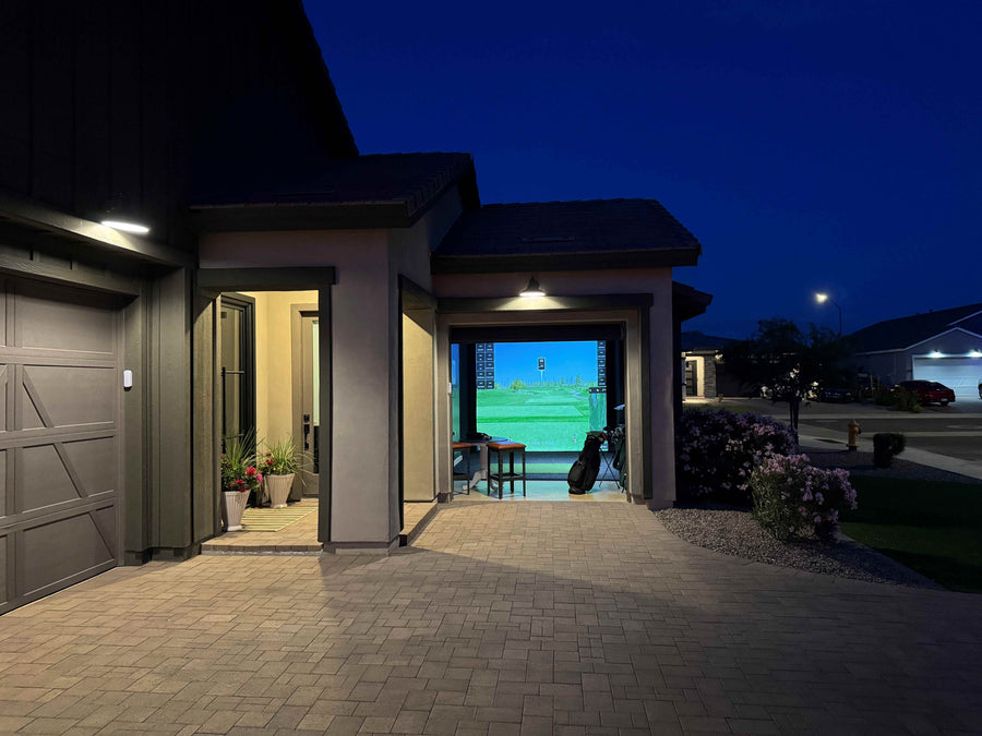Night view of a custom golf simulator installation in Queen Creek, AZ